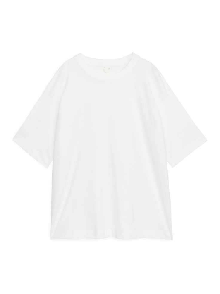 Made from long-staple pima cotton jersey, this soft t-shirt offers a roomy fit with dropped shoulders. This piece can be worn with jeans for an everyday look or dressed up with a skirt. CrewneckClean finish Boxy Fit Cotton Short Sleeve Top For Everyday, Everyday Boxy Fit Short Sleeve Cotton Top, Plain Cotton T-shirt With Drop Shoulder, Cotton Plain T-shirt With Drop Shoulder, Cotton Drop Shoulder Plain T-shirt, Oversized Simple Cotton T-shirt, Oversized Cotton Tops In Basic Style, Oversized Basic Cotton Top, Everyday Cotton T-shirt With Drop Shoulder