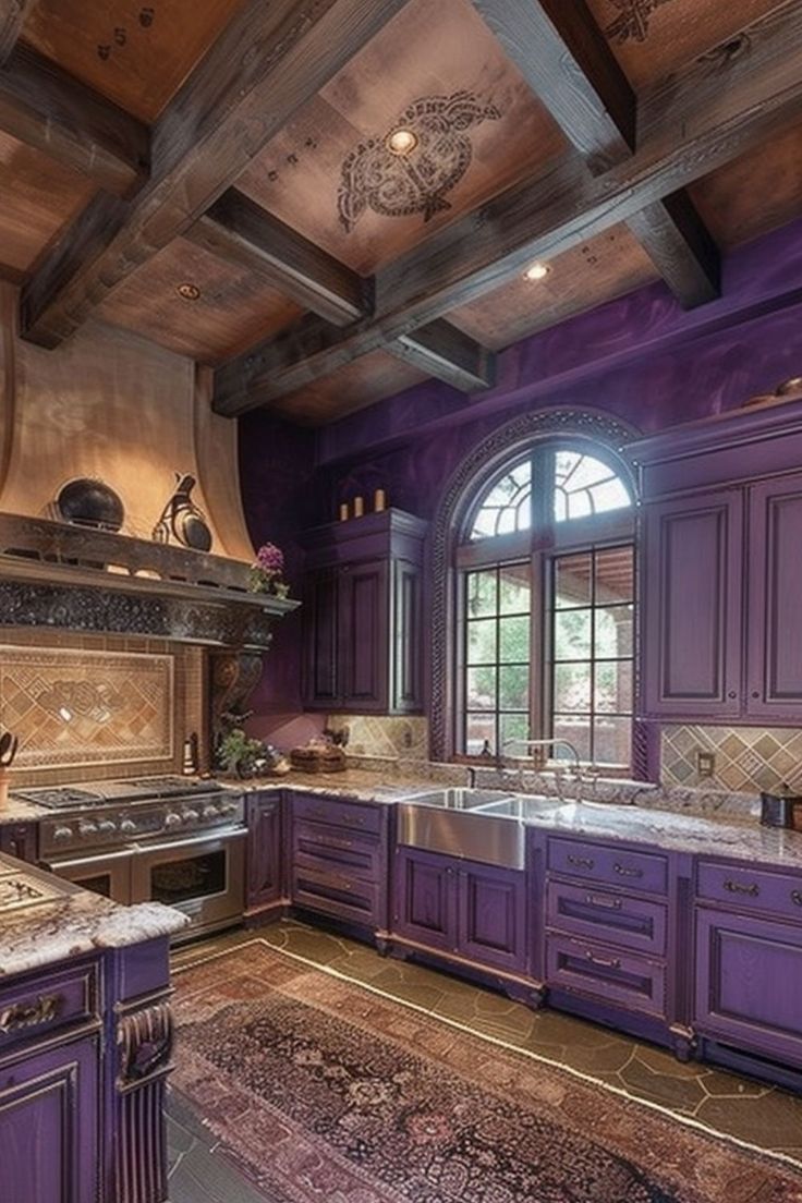 a large kitchen with purple cabinets and marble counter tops, along with an area rug on the floor