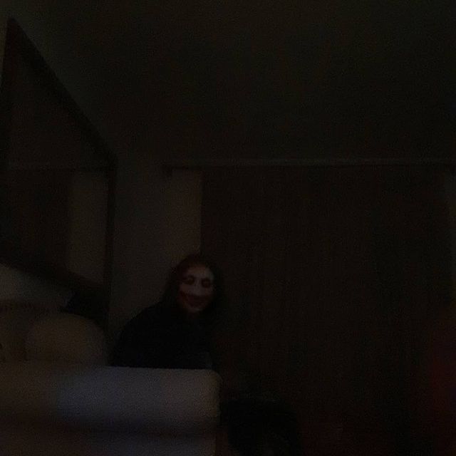 a person in the dark with a creepy face