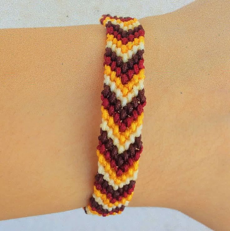 a close up of a person's arm wearing a bracelet made out of beads