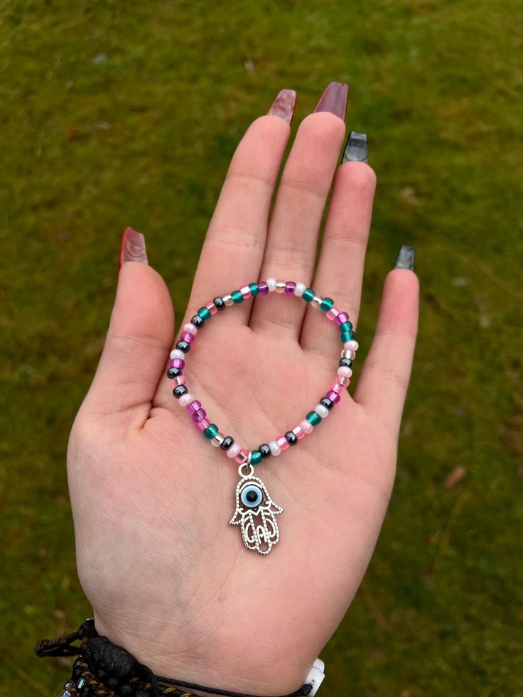 Handmade  Hamsa Hand Evil Eye Purple Pink and Blue Hawaii Mix Seed Beaded Stretchy Charm Bracelet Evil Eye Purple, Hand Evil Eye, Hand Beaded Jewelry, Beaded Charm Bracelet, Violet Rose, Blue Hawaii, Bead Charm Bracelet, Seed Bead Bracelets, Hamsa Hand