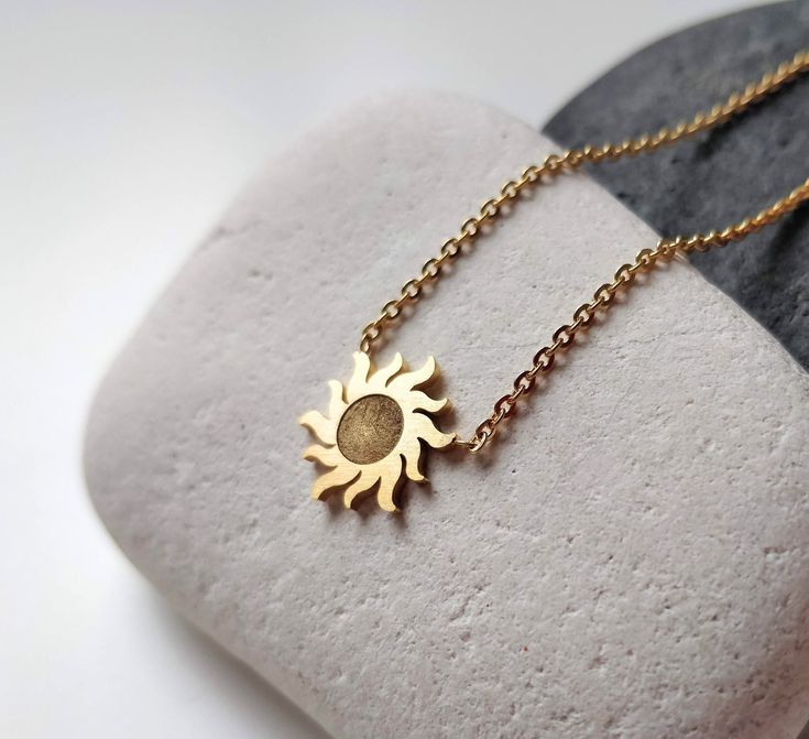 This amazing dainty sun necklace is such a great piece of every jewelry collection. The sunburst charm just brings good luck and happiness, good karma. This small gold sun pendant can be layered with other celestial necklace or worn on it's own. Pendant Size: 1.2 cm x 1.2 cm All my jewellery is lead and nickle free. I am attaching the minimalist sun charms on gold chain, which I cut to size to create something pretty just for you.   ✽ ENVIRONMENTAL FRIENDLY PACKAGE I was always feeling bad for creating more waste on this planet so I try to be environmental friendly everywhere where possible. All my wrapping material is biodegradable and recyclable :) My jewelry comes on A6 designed paper in a biodegradable cellophane bag which can either go to compost or landfills as it will disappear in a Celestial Sun Design Necklaces For Gifts, Celestial Sun Design Necklaces As A Gift, Celestial Style Necklaces With Sun Design For Gifts, Celestial Sun Design Necklaces As Gifts, Sun-shaped Jewelry With Sun And Moon Design For Gift, Dainty Sun And Moon Charm Necklaces As A Gift, Dainty Sun And Moon Charm Necklace For Gift, Dainty Sun And Moon Charm Necklace Gift, Dainty Sun And Moon Design Charm Necklace As Gift