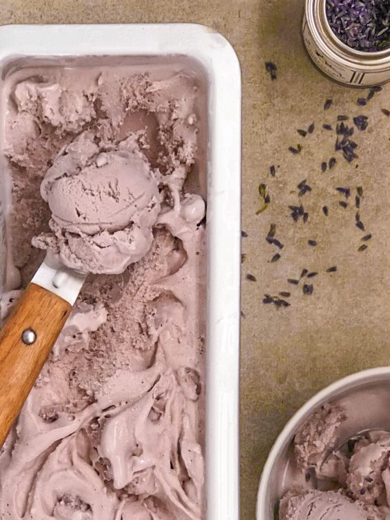 two bowls filled with ice cream on top of a table next to spoons and salt shakers