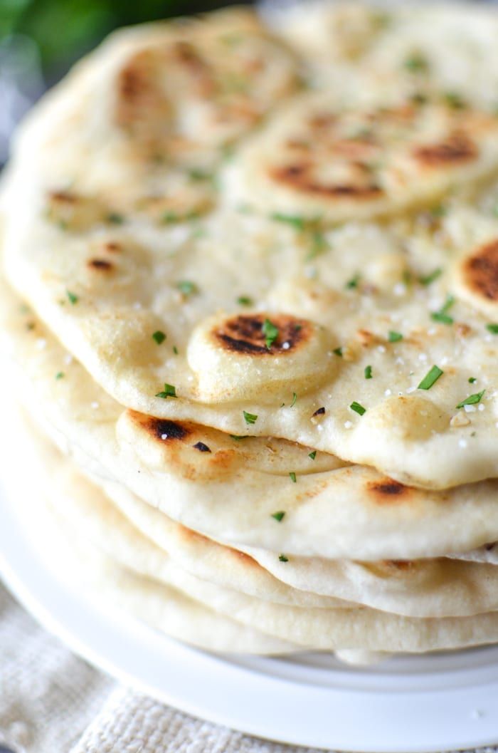 a stack of flat bread on a white plate