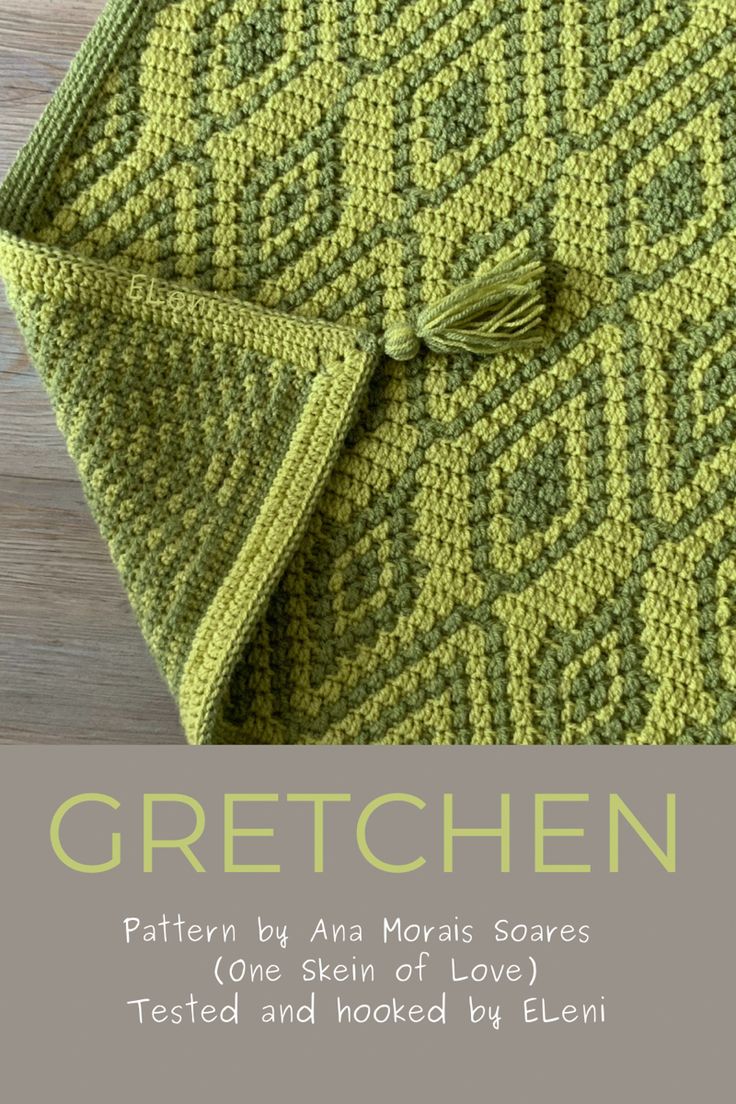 a green knitted blanket sitting on top of a wooden floor with the words, croche