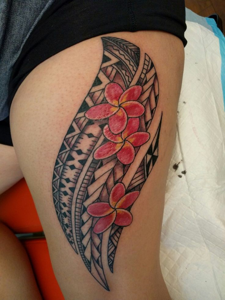 a woman's thigh with a flower tattoo on it