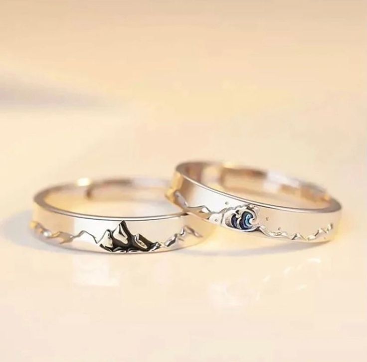 two silver rings sitting on top of each other