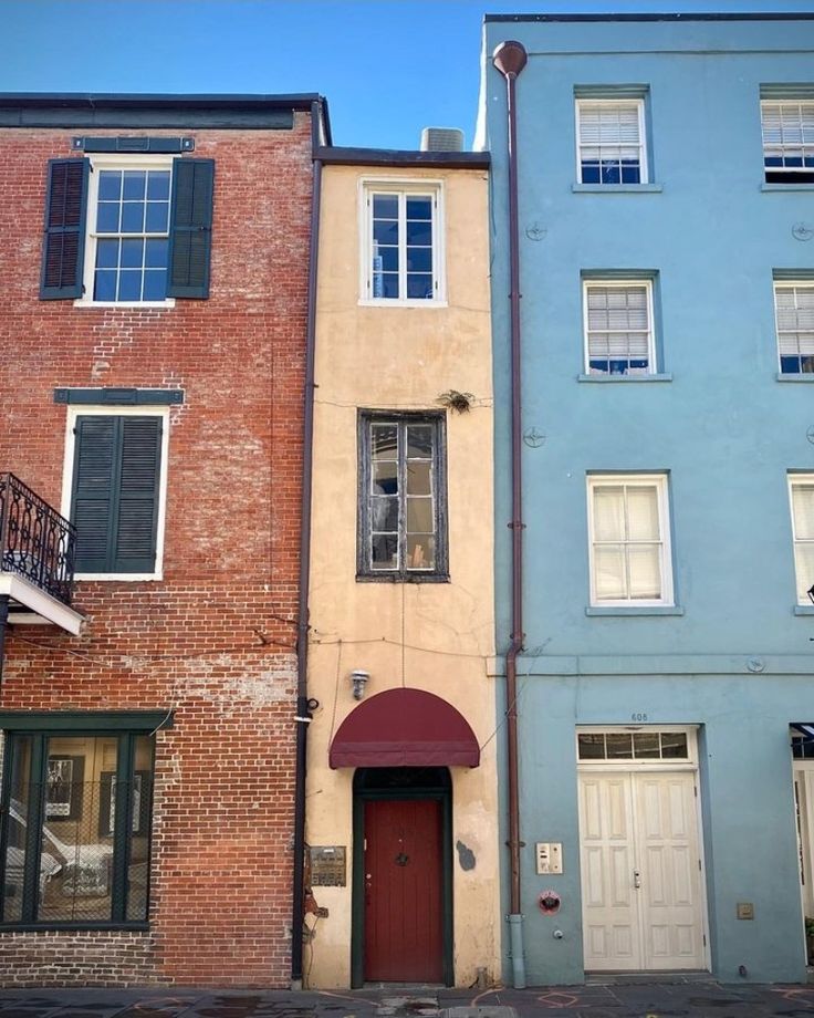 several different colored buildings line the street in front of each other