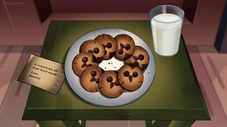 there is a plate of cookies on the table with a glass of milk next to it