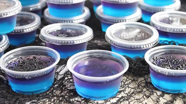 several jars filled with blue liquid sitting on top of a table