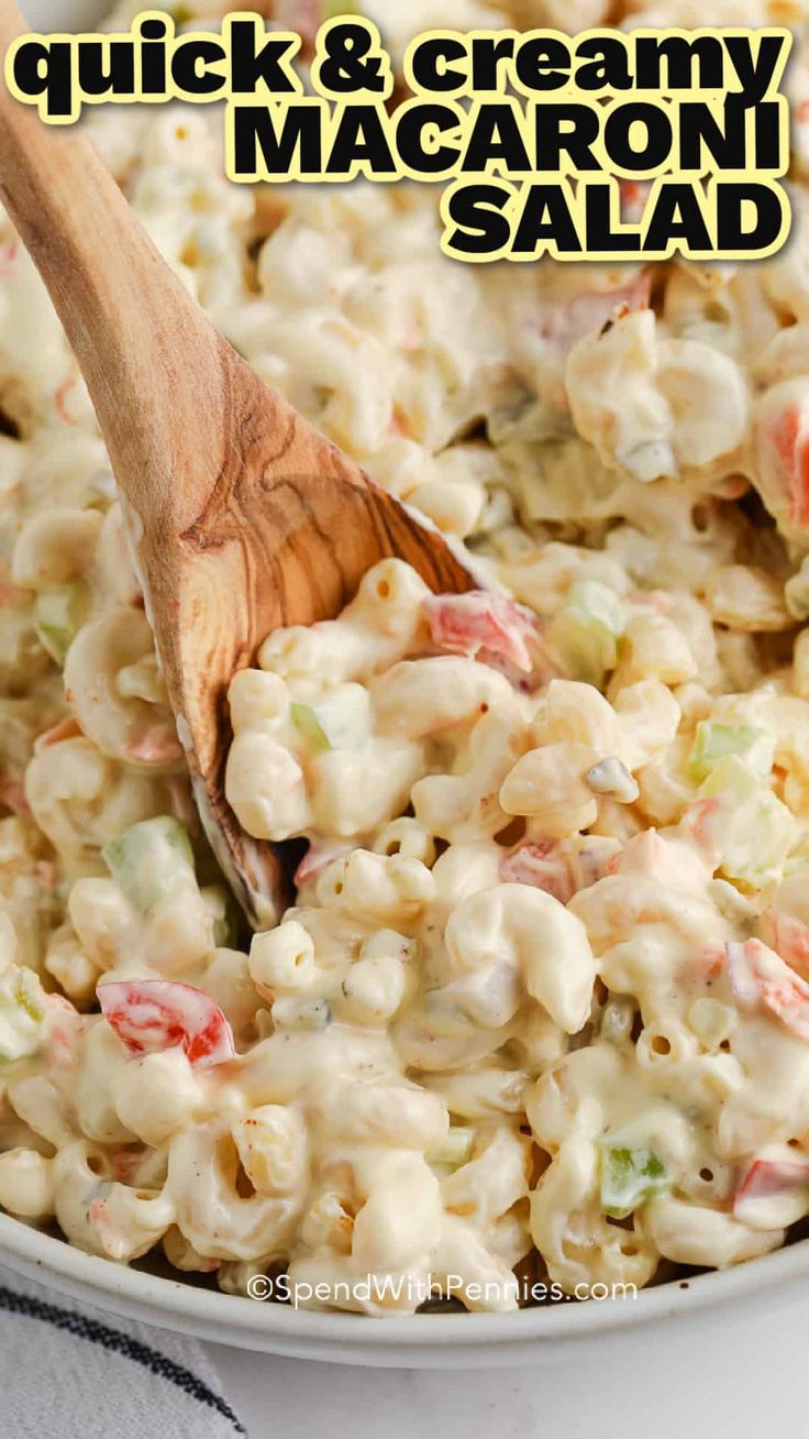 macaroni salad in a white bowl with a wooden spoon on top and text overlay reading quick & creamy macaroni salad