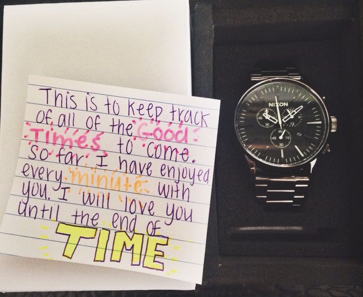 a note that has been placed next to a watch in a box with writing on it