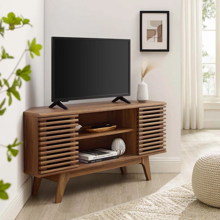 an entertainment center with a flat screen tv on it's stand in a living room