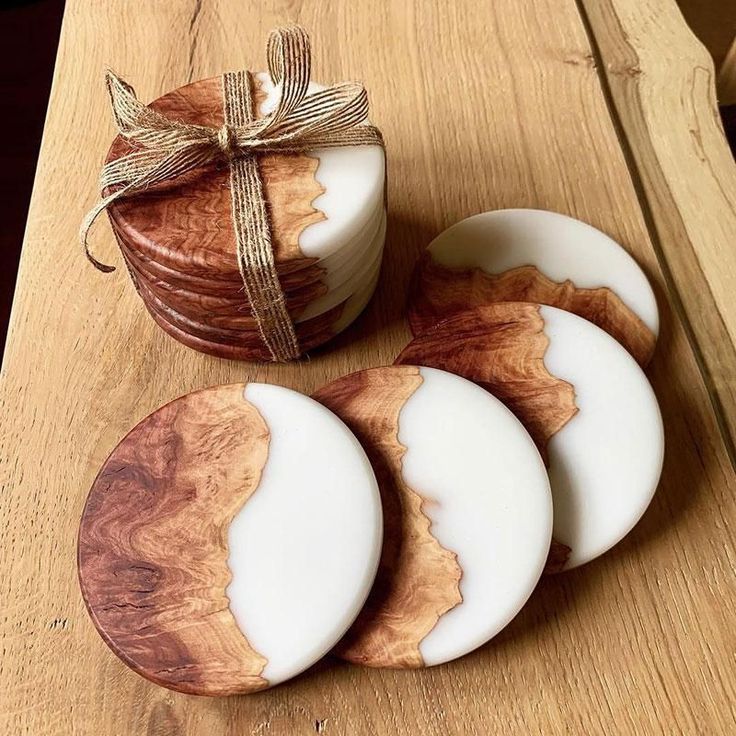 three wooden coasters sitting on top of a table next to a wrapped present box