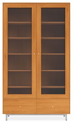 a wooden bookcase with glass doors on the front and bottom shelves in light wood