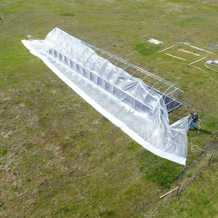 an aerial view of a large white structure in the middle of a field