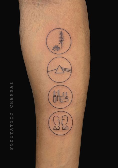 a person with a tattoo on their leg that has four different symbols in the shape of circles