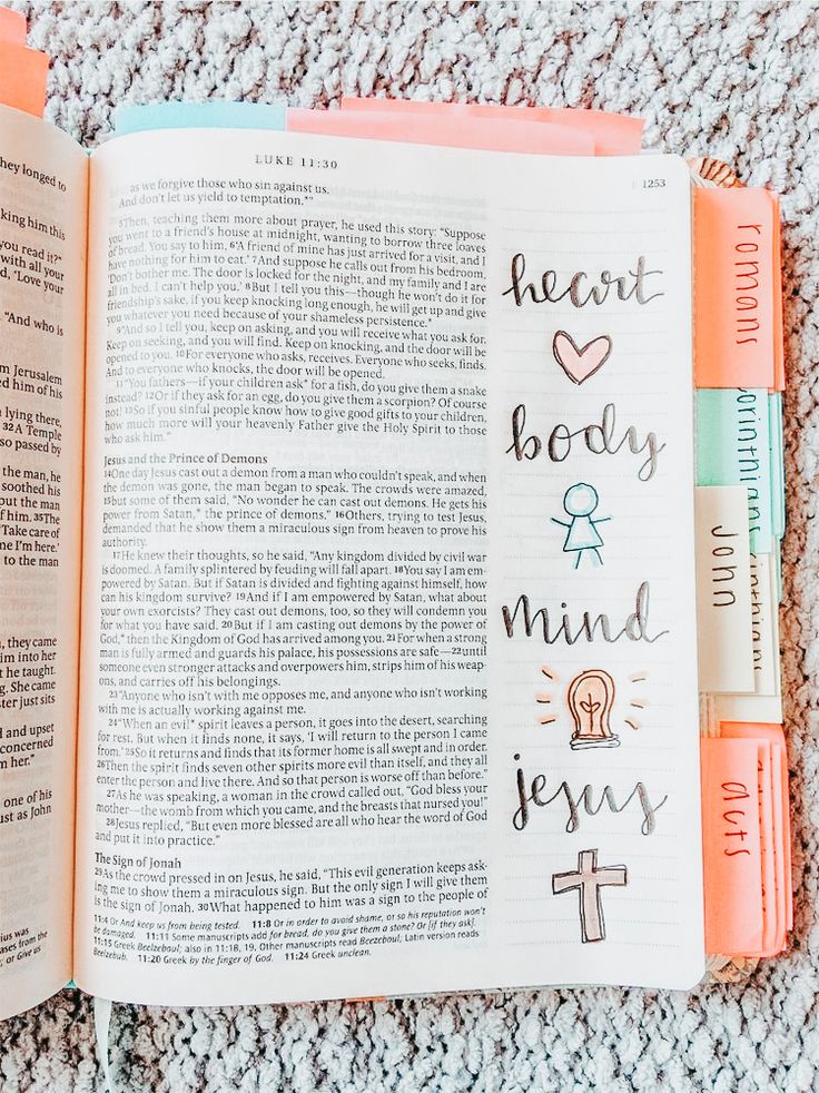 an open bible with the words heart body and mind jesus written in cursive writing