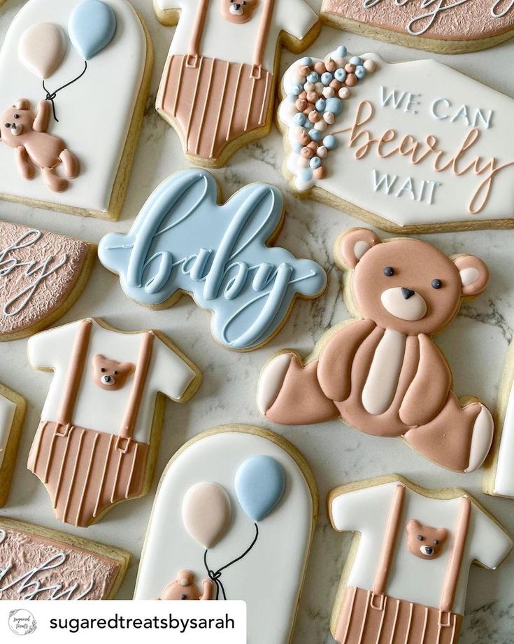 decorated cookies with baby's first and second names are displayed on a countertop