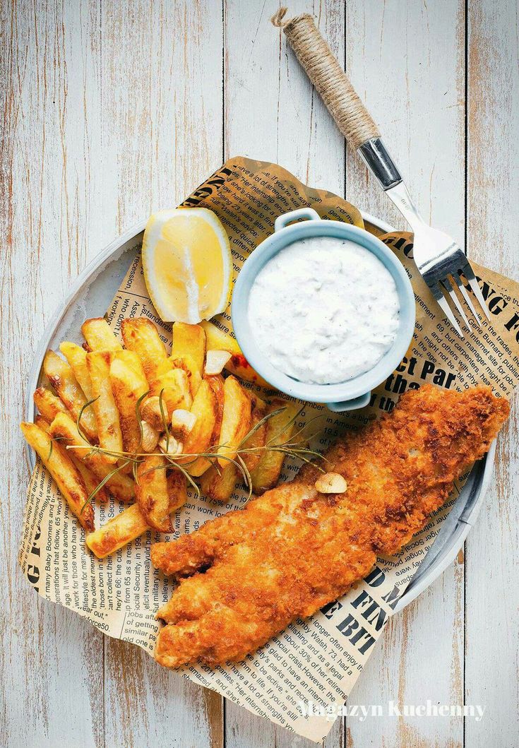 fried fish and fries on a plate with dip