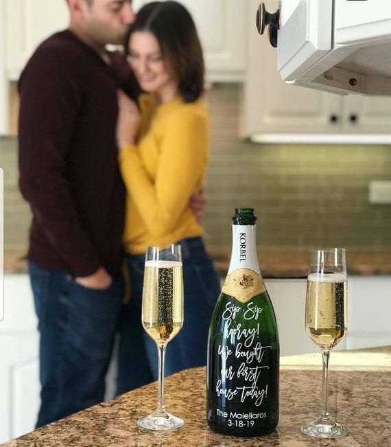 a man and woman standing next to each other with champagne glasses in front of them