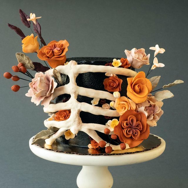 a black and white cake with flowers on top