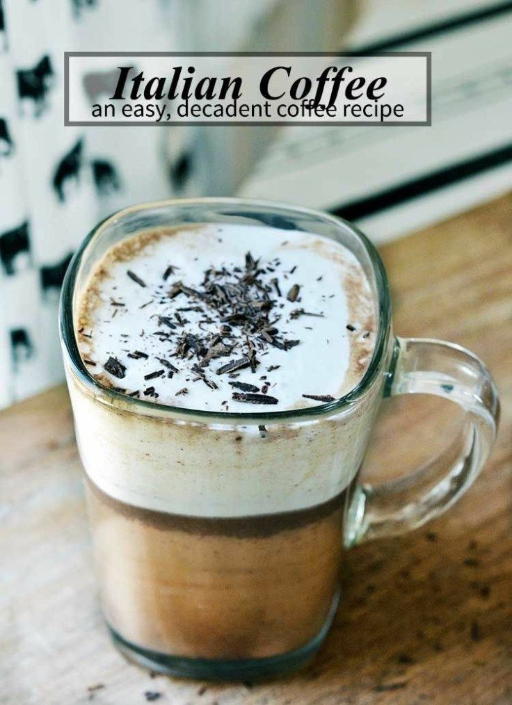 a glass mug filled with coffee and topped with whipped cream, chocolate shavings