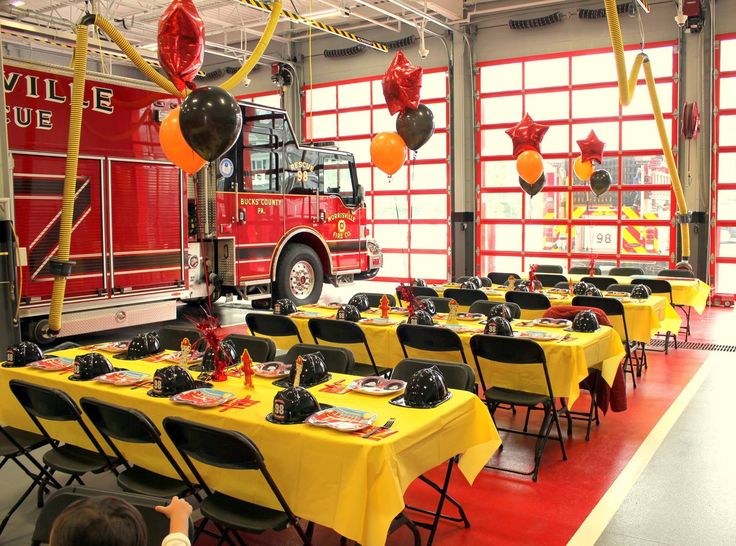 a fire truck themed birthday party with yellow table cloths