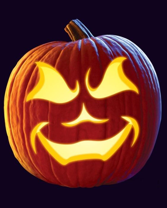 a pumpkin with an evil face carved into it