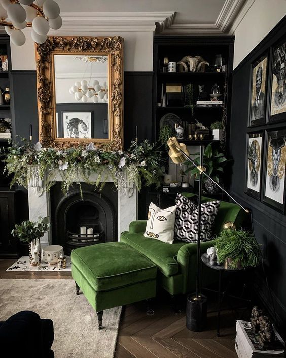 a living room with green couches and pictures hanging on the wall above it's fireplace