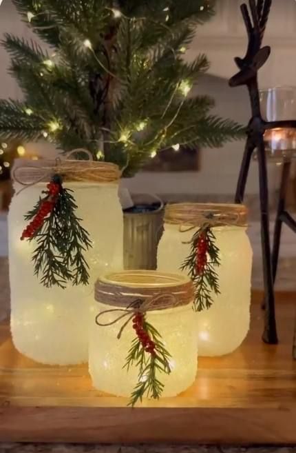 three mason jars with christmas decorations on them