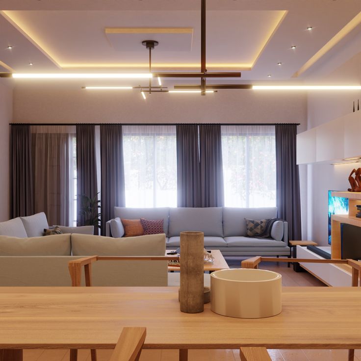 a living room filled with furniture and a flat screen tv mounted to the wall next to a window