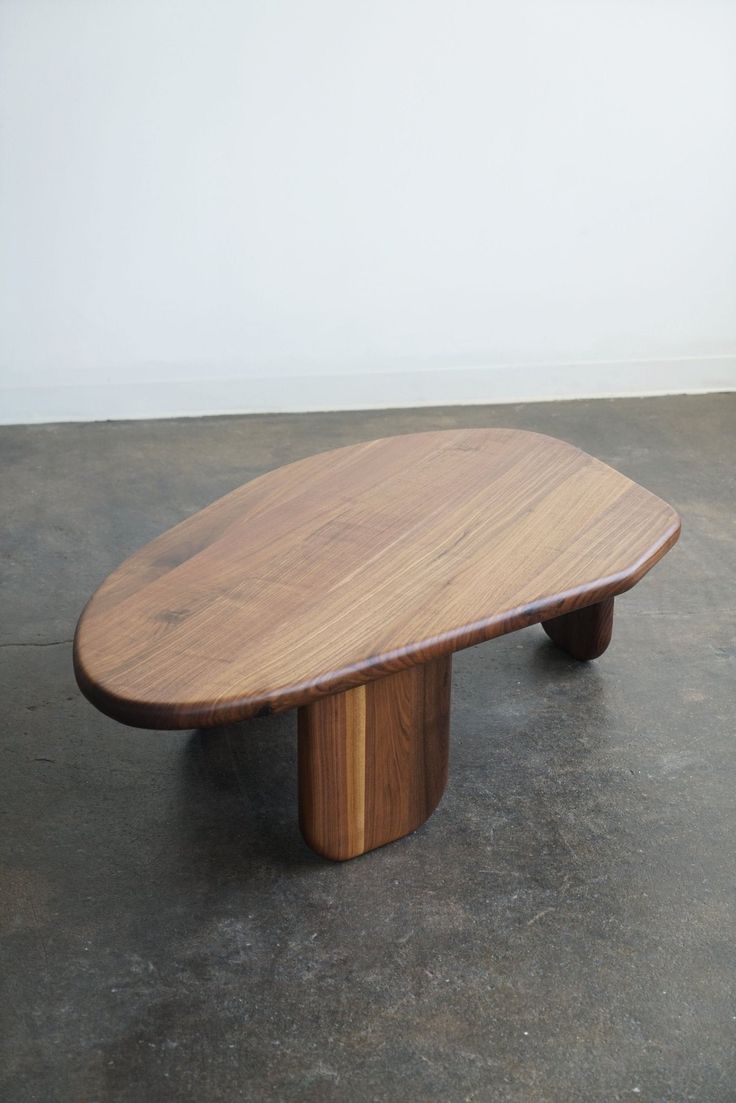 a wooden table sitting on top of a cement floor