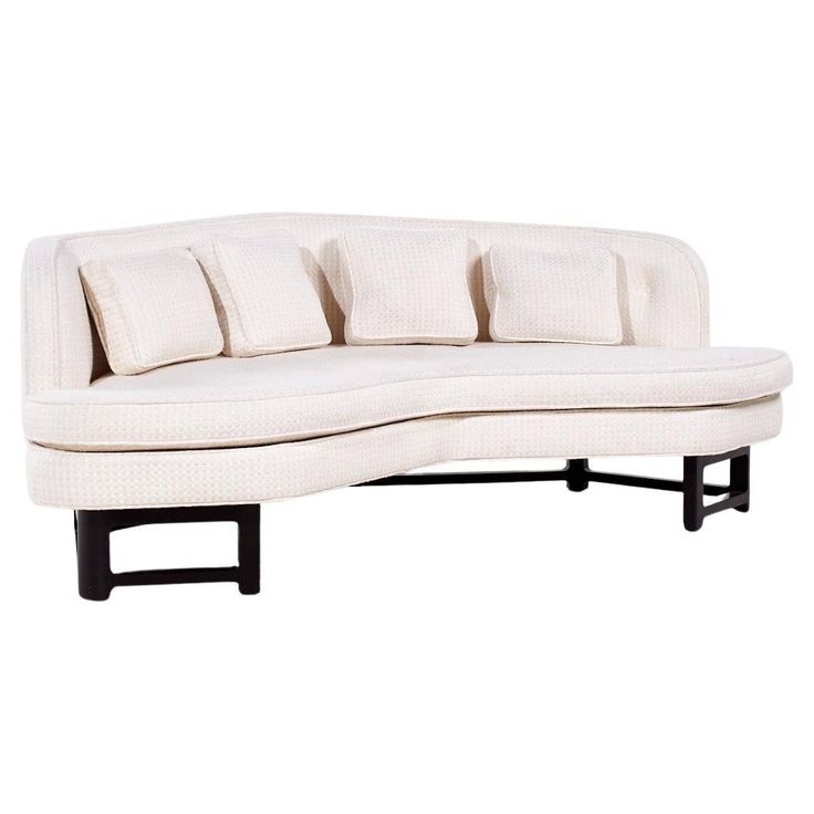 a white couch with four pillows on it