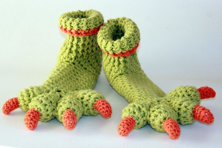 two crocheted feet with red and green decorations on them