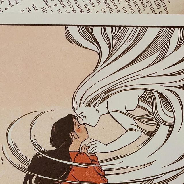 an image of a woman with long hair kissing another woman's face in front of a book