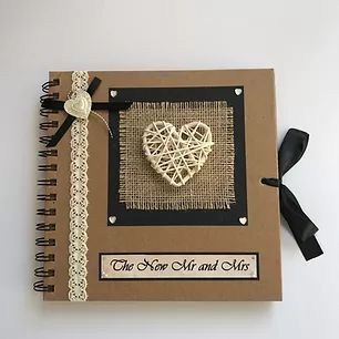 a notebook with a string heart on the cover and ribbon attached to it that says, the new mr and mrs