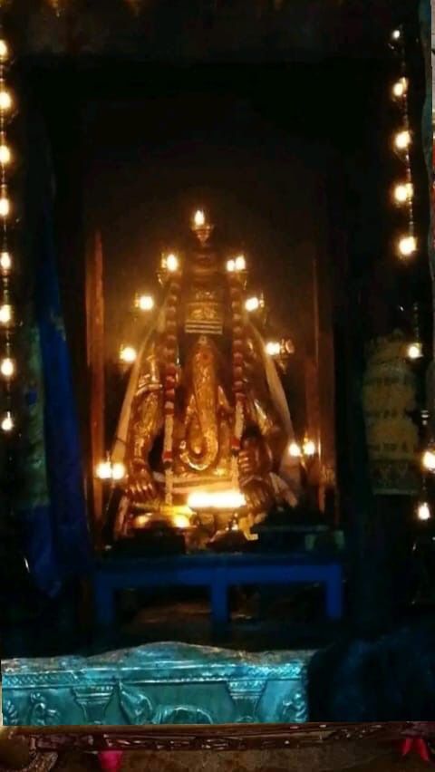 an image of the inside of a temple with lights around it and buddha statue in front