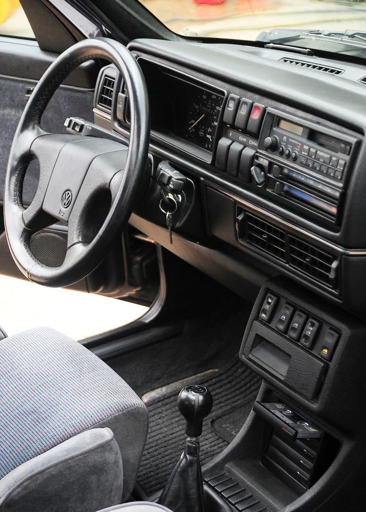 the interior of a car with dashboard controls and steering wheel, dash board and radio