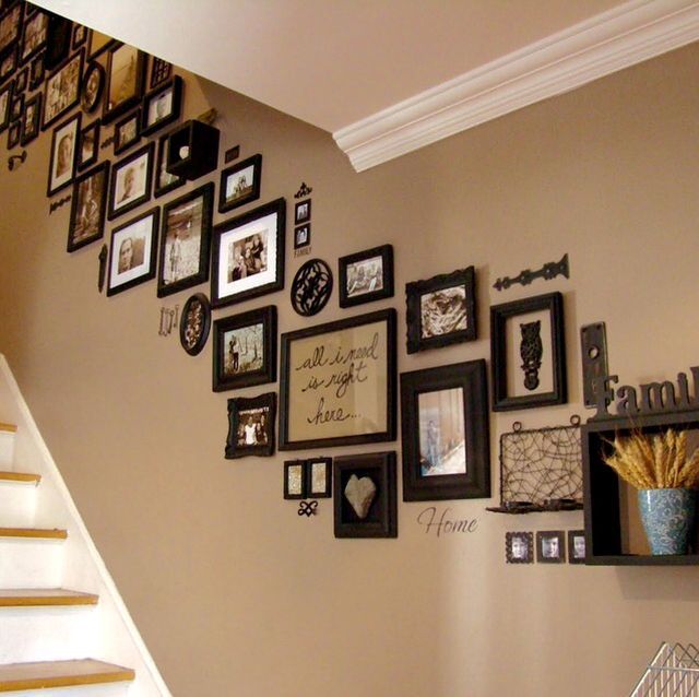 a staircase with many framed pictures on the wall