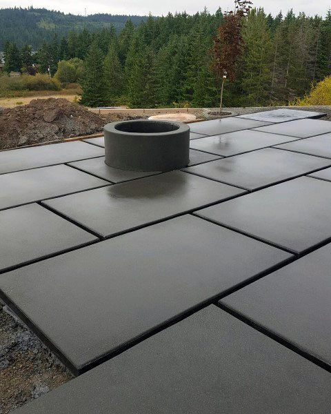 a large concrete slab with a fire pit on top