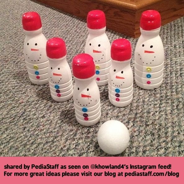 a group of plastic bowling pins sitting on top of a carpeted floor next to a white ball