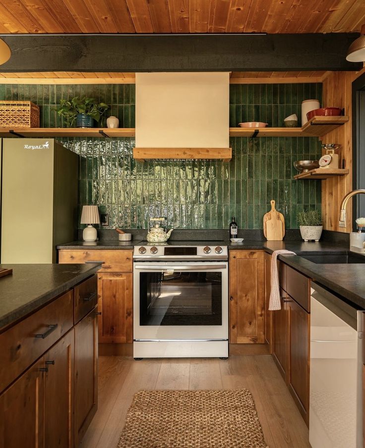 a kitchen with wooden cabinets and green tile backsplashing on the wall above the stove