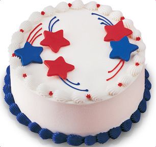 a white cake with red, white and blue stars on the icing is shown