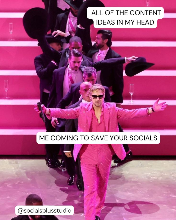 a man in a pink suit and sunglasses walking down the runway with his arms outstretched