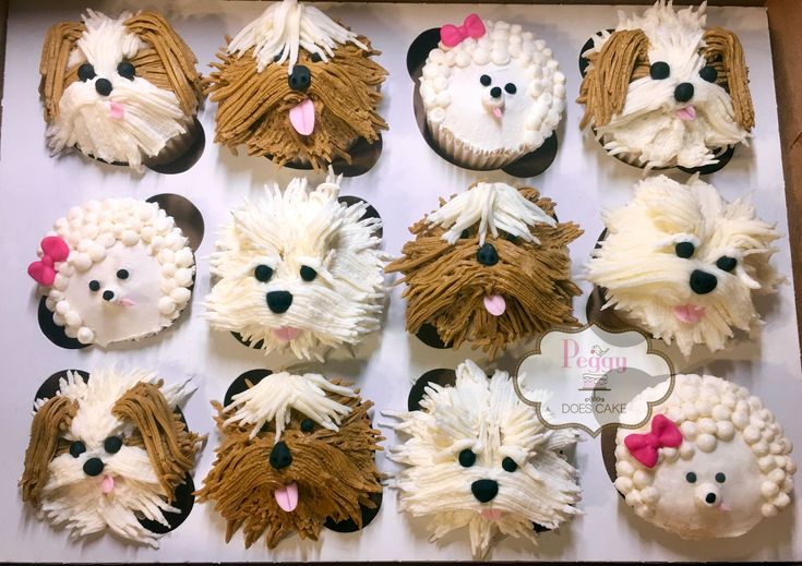 twelve cupcakes in the shape of dogs and sheep