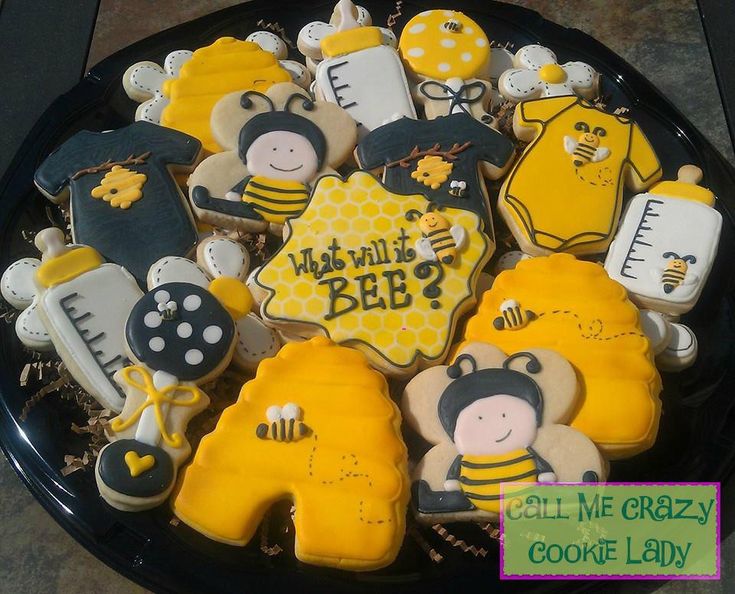 decorated cookies in the shape of babies and bees