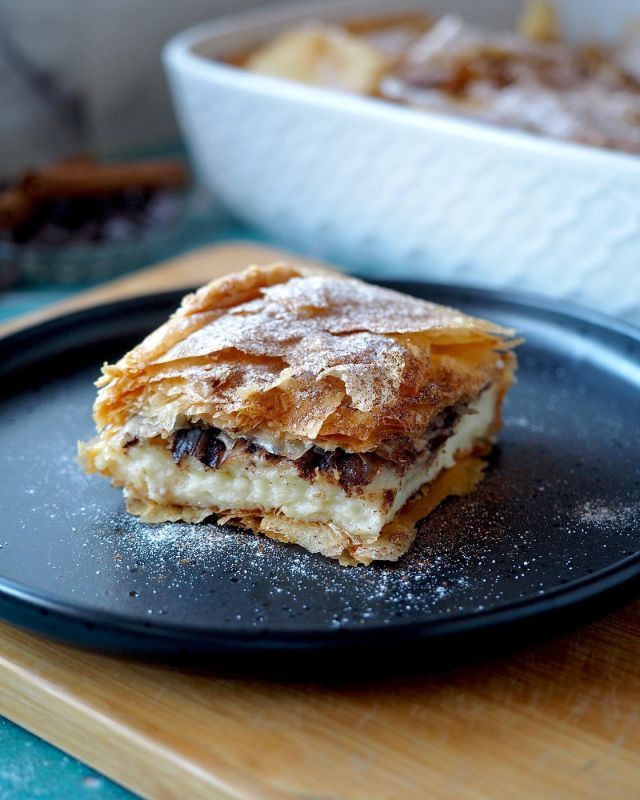 a piece of dessert sitting on top of a black plate