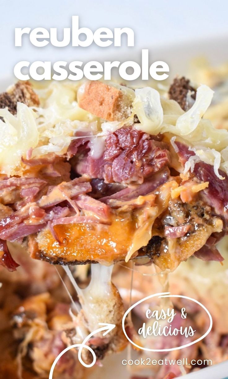 a casserole with meat and cheese is being lifted from the casserole dish