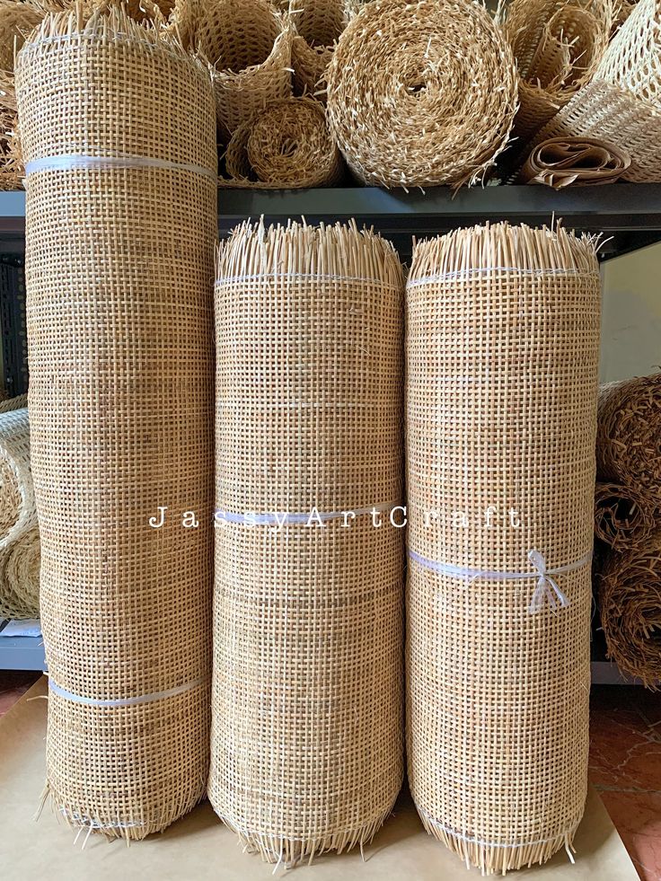 three rolls of jute sitting next to each other on top of a shelf in a store